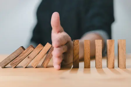 ODT Consulting - Hand stops falling dominos